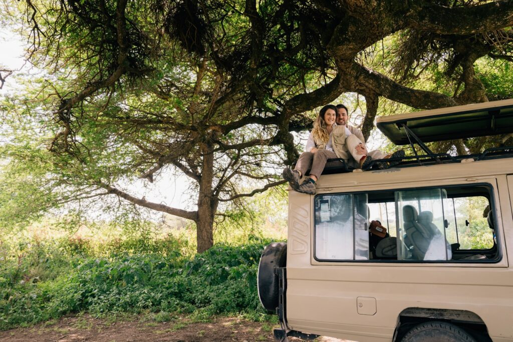 Couple enjoys the view from their safari vehicle.